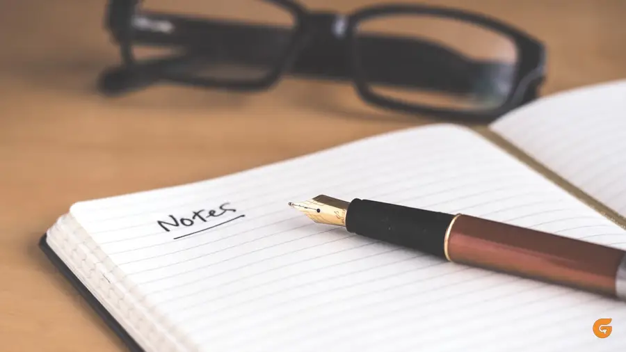 A journal, pen and coffee cup