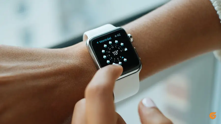 A watch and notebook on a desk