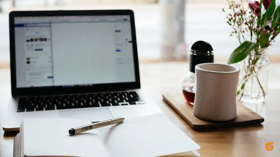 Taking notes beside a laptop
