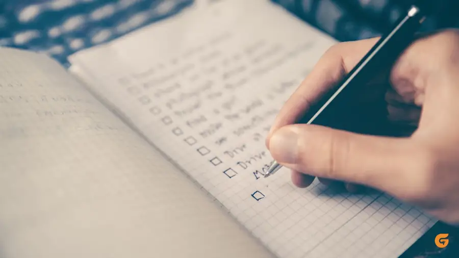 A phone and planner on a work desk
